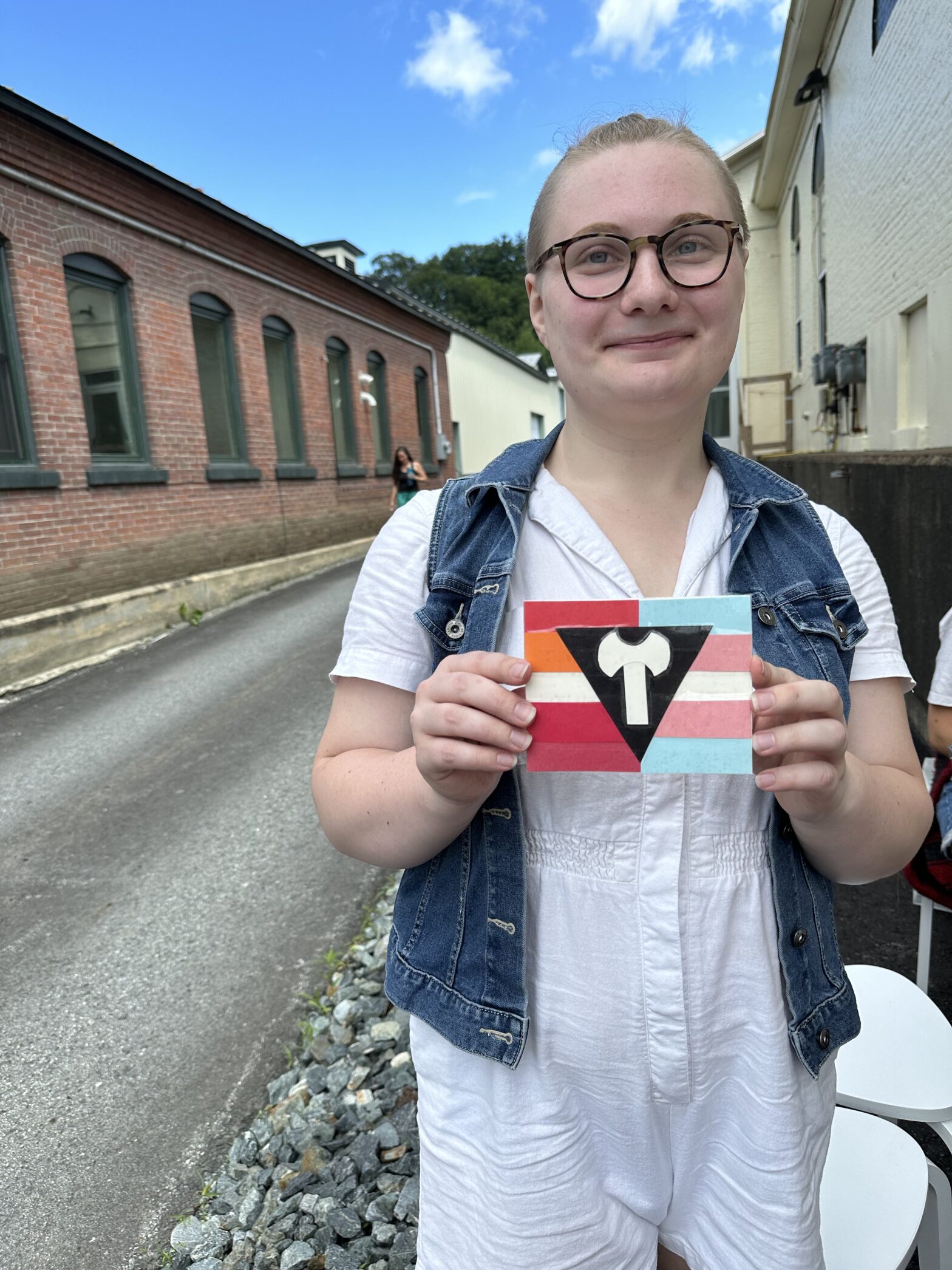 Person holds up pride flag that they made.